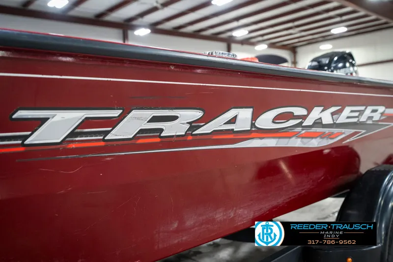 Slide: The Image of Red 2021 Tracker Super Guide 17 boat in showroom with logo visible. - 39