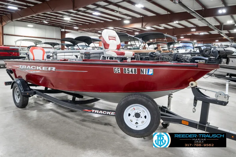 Slide: The Image of 2021 Tracker Super Guide 17 boat in showroom, red exterior, on trailer. - 4