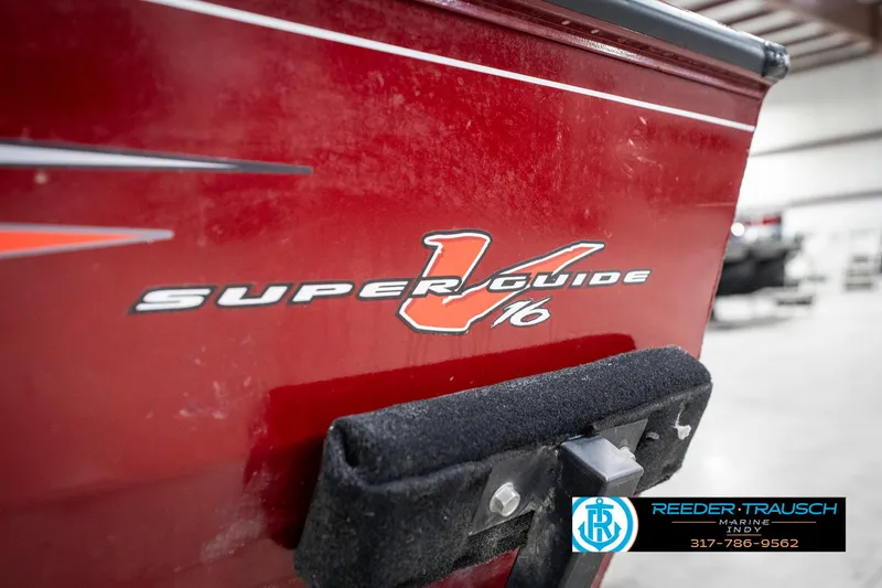 Slide: The Image of 2021 Tracker Super Guide 17 boat, red exterior, close-up view in a showroom. - 40