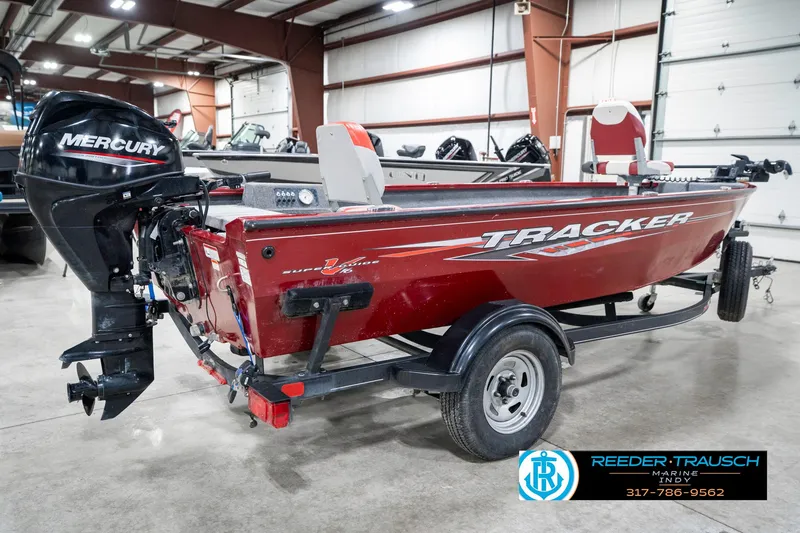 Slide: The Image of 2021 Tracker Super Guide 17 boat with Mercury engine in a showroom. - 6