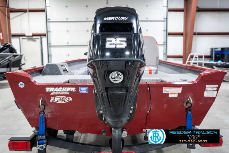 Slide: The Image of 2021 Tracker Super Guide 17 boat with Mercury 25 outboard motor in a garage. - 7