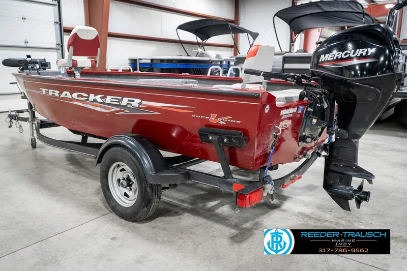 Slide: The Image of 2021 Tracker Super Guide 17 boat with Mercury engine in indoor showroom. - 8