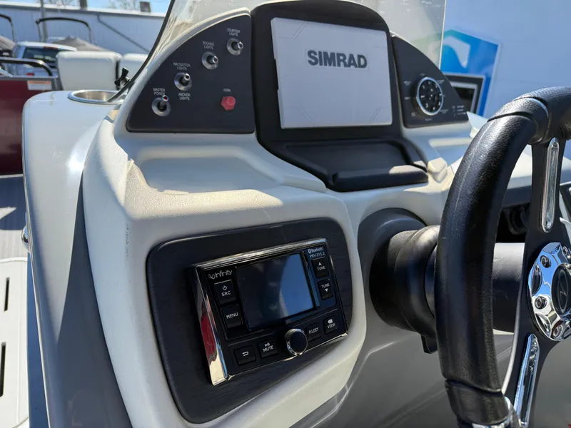 Slide: The Image of 2021 Veranda Relax VR22RC boat dashboard with Simrad display and controls. - 21