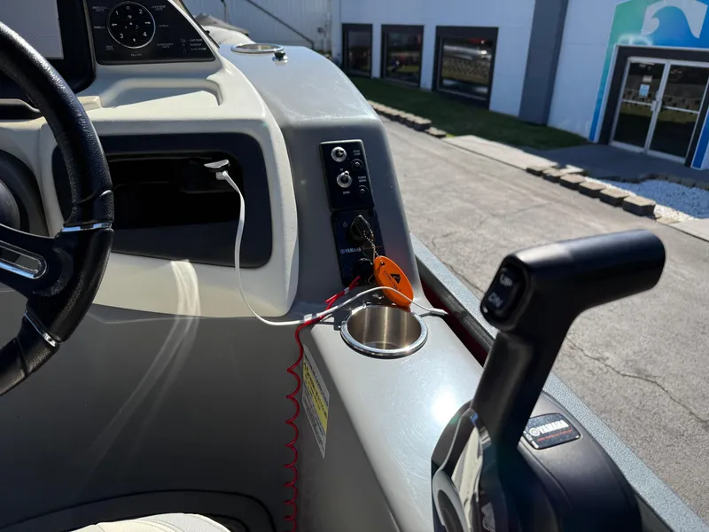 Slide: The Image of Control panel of a 2021 Veranda Relax VR22RC boat, featuring steering wheel and throttle. - 22