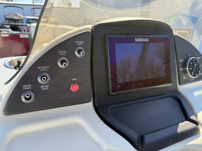 Slide: The Image of Control panel of a 2021 Veranda Relax VR22RC boat with Simrad display and switches. - 24
