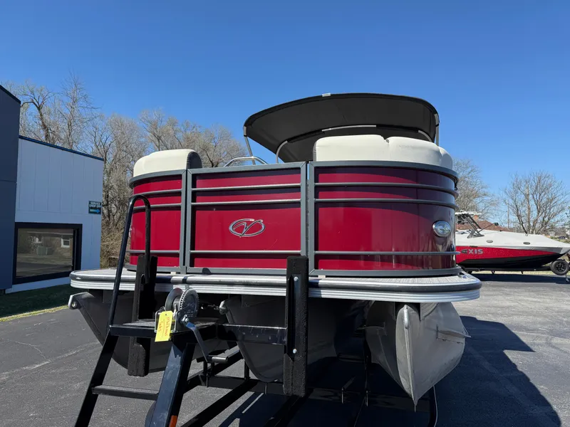 Slide: The Image of 2021 Veranda Relax VR22RC pontoon boat with red exterior, parked outdoors under clear blue sky. - 3