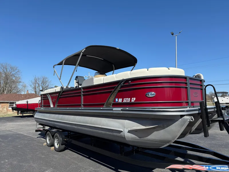 Slide: The Image of 2021 Veranda Relax VR22RC pontoon boat with red exterior on a trailer. - 5
