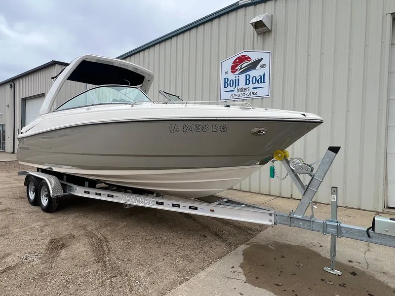 Slide: The Image of 2009 Monterey 254FS boat on trailer outside Boji Boat Brokers building. - 1