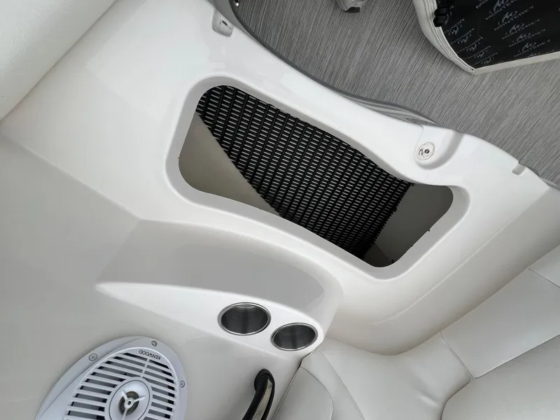 Slide: The Image of Interior of a 2009 Monterey 254FS boat showing speaker and storage compartment. - 12