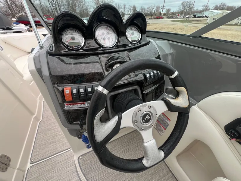 Slide: The Image of Dashboard of a 2009 Monterey 254FS boat with steering wheel and gauges. - 15