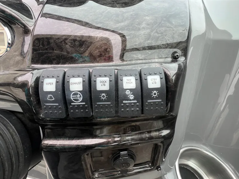 Slide: The Image of Control panel of a 2009 Monterey 254FS boat with labeled switches. - 17