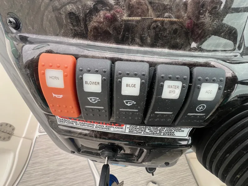 Slide: The Image of Control panel of a 2009 Monterey 254FS boat with labeled switches. - 18