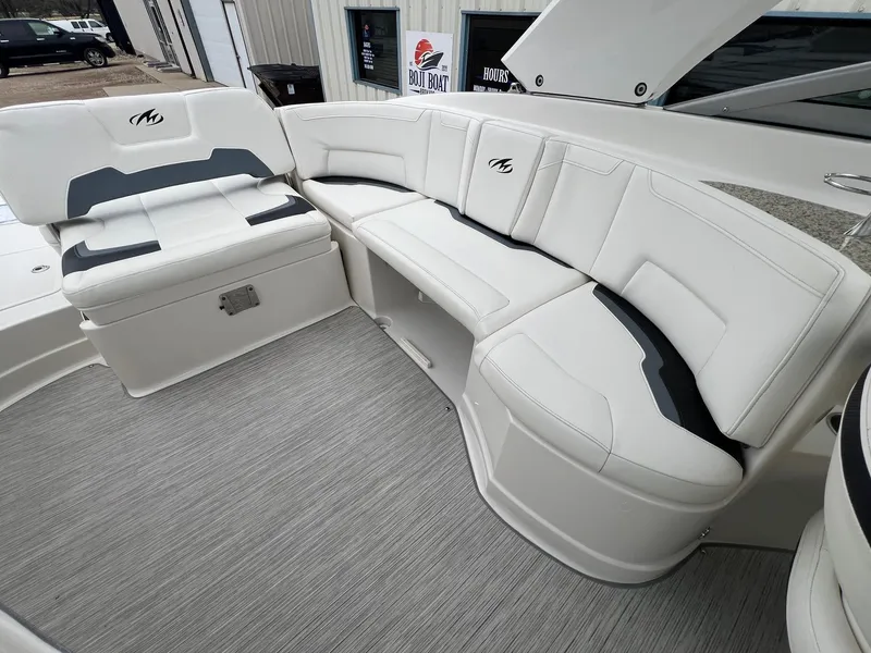 Slide: The Image of 2009 Monterey 254FS boat interior with white cushioned seating and gray flooring. - 23