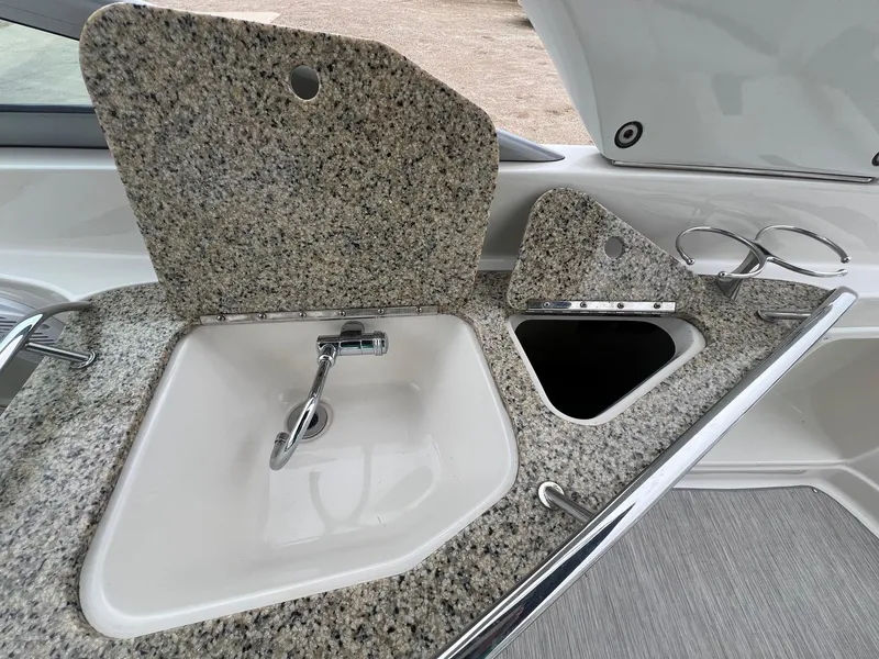 Slide: The Image of Granite countertop with sink and faucet on 2009 Monterey 254FS boat. - 25