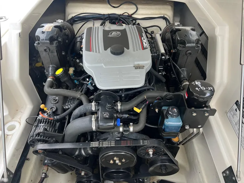 Slide: The Image of Engine compartment of a 2009 Monterey 254FS boat, showcasing detailed mechanical components. - 30