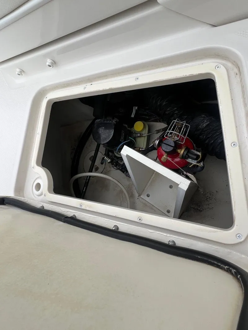 Slide: The Image of Open engine compartment of a 2009 Monterey 254FS boat, showing mechanical components. - 34