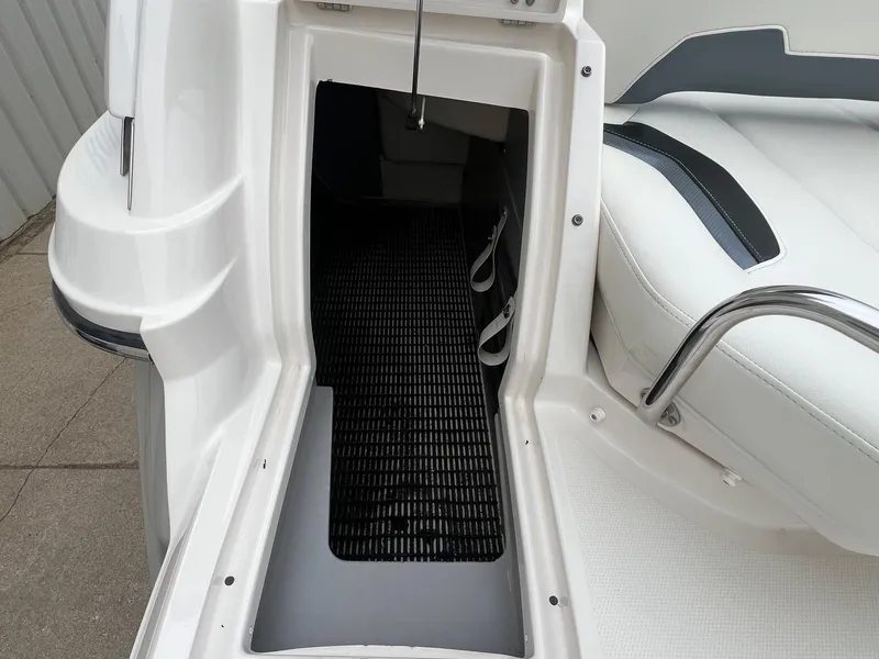 Slide: The Image of 2009 Monterey 254FS boat interior storage compartment with seating and white finish. - 36