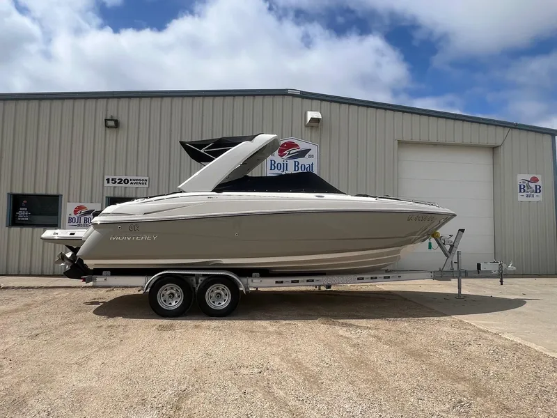 Slide: The Image of 2009 Monterey 254FS boat on trailer outside Boji Boat dealership. - 38