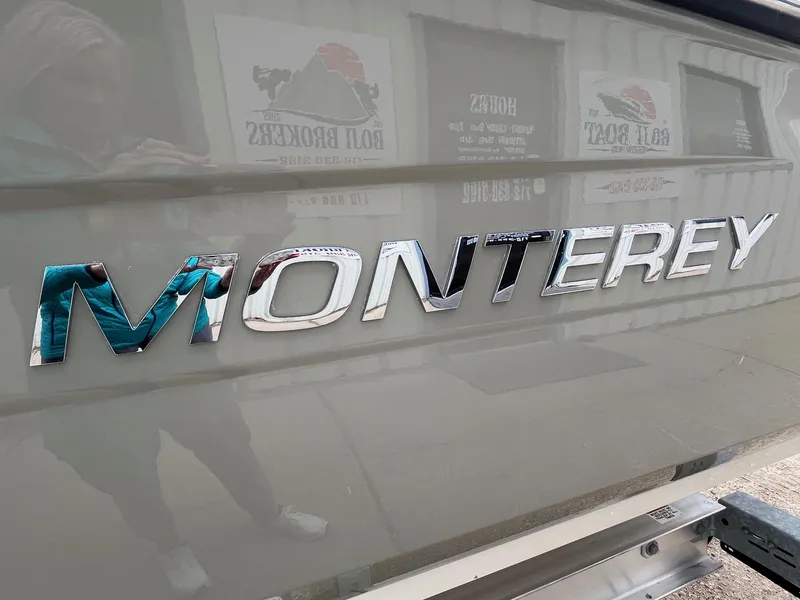 Slide: The Image of Monterey 254FS 2009 boat logo in chrome on a sleek surface. - 4
