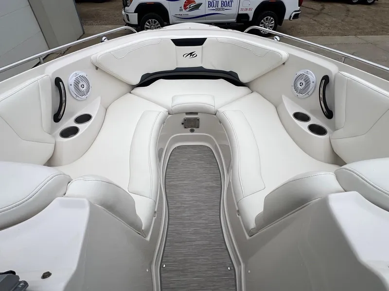 Slide: The Image of 2009 Monterey 254FS boat interior with white seating and cup holders. - 8