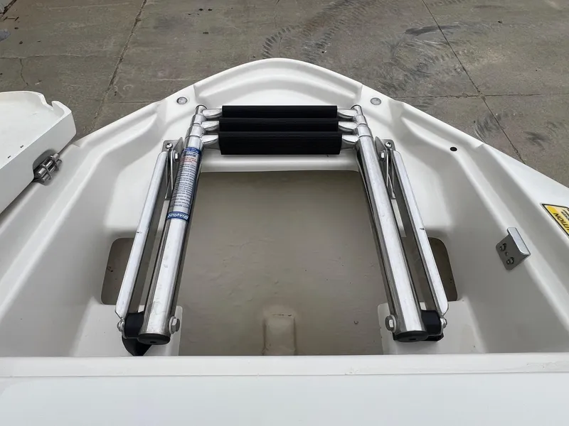 Slide: The Image of 2009 Monterey 254FS boat ladder, stainless steel, folded on deck. - 9