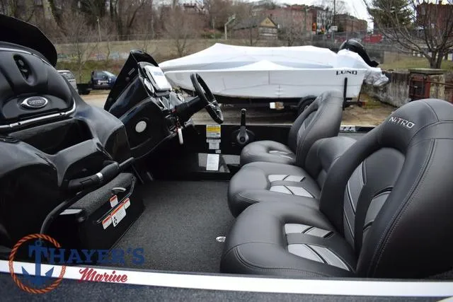 Slide: The Image of 2020 Nitro Z17 boat interior with sleek black seating and modern dashboard. - 11