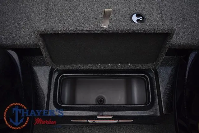 Slide: The Image of Open storage compartment in 2020 Nitro Z17 boat, featuring carpeted interior and latch. - 22