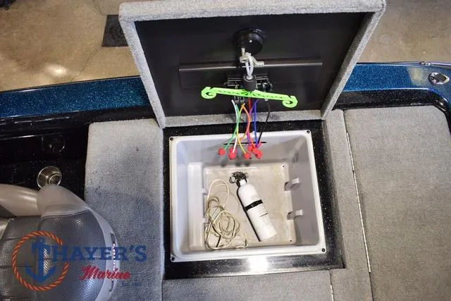 Slide: The Image of Storage compartment in a 2012 Stratos 294 XLE boat with wiring and a fire extinguisher. - 25