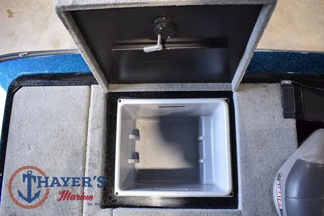 Slide: The Image of Open storage compartment in a 2012 Stratos 294 XLE boat, featuring Thayer's Marine logo. - 26