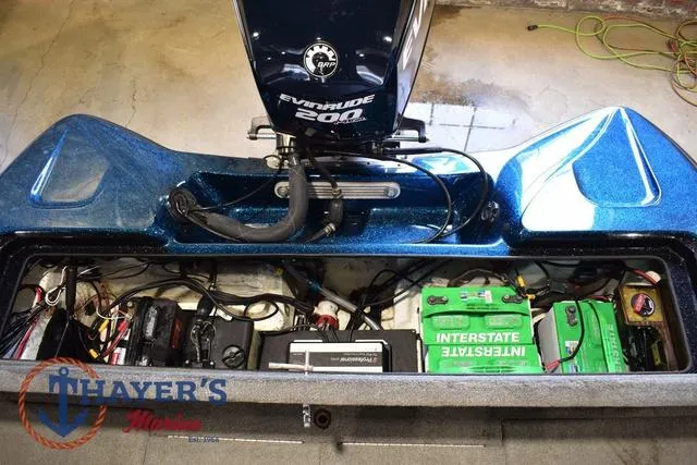 Slide: The Image of 2012 Stratos 294 XLE boat engine compartment with Evinrude 200 motor and Interstate batteries. - 27