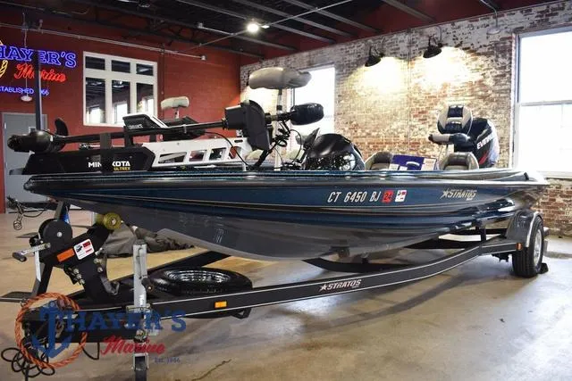 Slide: The Image of 2012 Stratos 294 XLE fishing boat on trailer in showroom. - 6