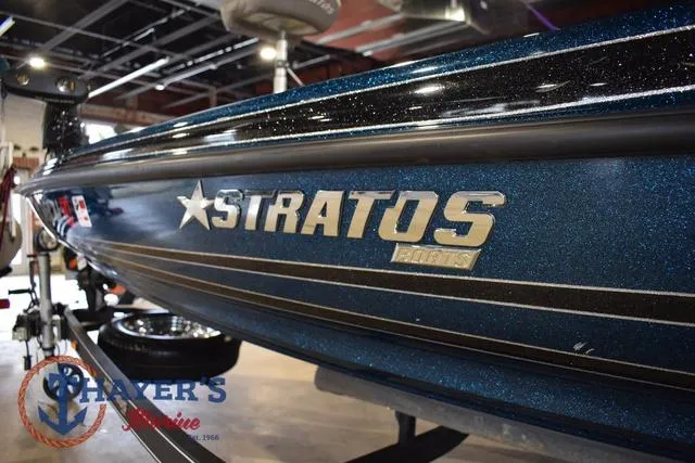Slide: The Image of 2012 Stratos 294 XLE boat with metallic blue finish in showroom. - 8