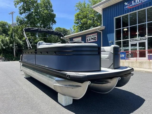 Slide: The Image of 2024 Viaggio Lago V-20C Triple pontoon boat parked outside dealership. - 3