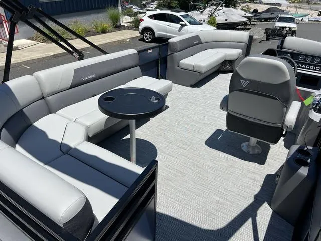 Slide: The Image of 2024 Viaggio Lago V-20C Triple pontoon boat interior with gray seating and round table. - 8