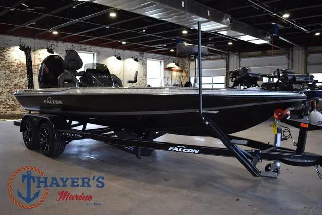 Slide: The Image of 2025 Falcon Bass Boats F20 TE in showroom, displayed on trailer at Thayer's Marine. - 1
