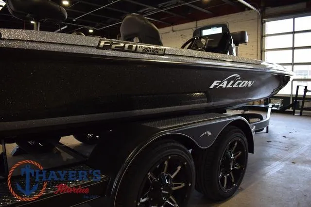 Slide: The Image of 2025 Falcon Bass Boats F20 TE in showroom, side view with trailer. - 14