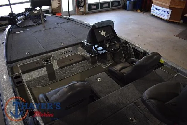Slide: The Image of 2025 Falcon Bass Boats F20 TE interior with seating and steering console in a showroom. - 19