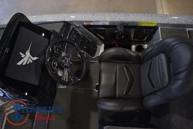 Slide: The Image of 2025 Falcon Bass Boats F20 TE cockpit with steering wheel and black leather seat. - 20