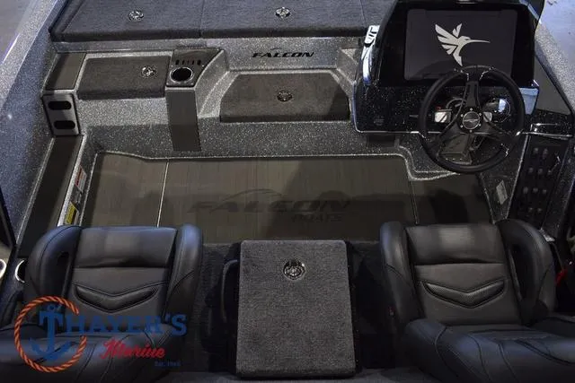 Slide: The Image of 2025 Falcon Bass Boats F20 TE interior with steering wheel and seating, featuring Thayer's Marine logo. - 22