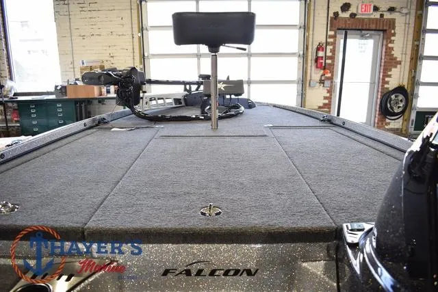 Slide: The Image of 2025 Falcon Bass Boats F20 TE interior with fishing deck and seat in a garage setting. - 31