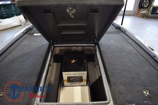 Slide: The Image of Open storage compartment in 2025 Falcon Bass Boats F20 TE, featuring a box inside. - 32