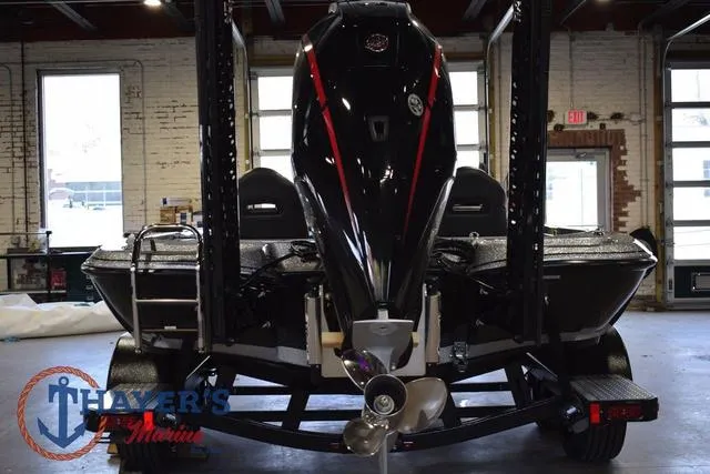 Slide: The Image of 2025 Falcon Bass Boats F20 TE in a garage, rear view with motor and trailer. - 4