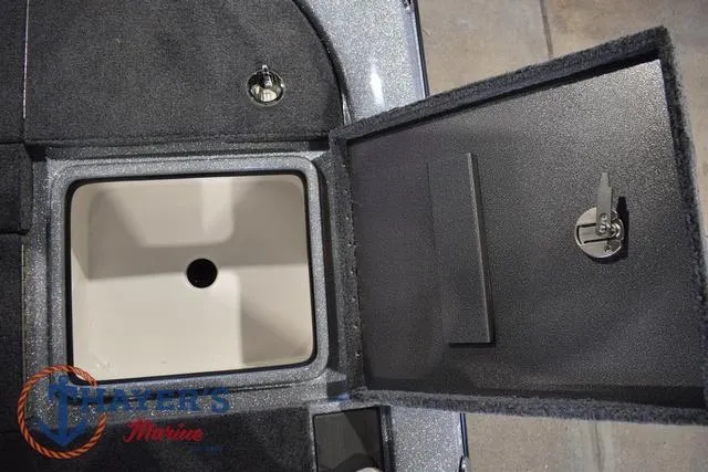 Slide: The Image of Open storage compartment on 2025 Falcon Bass Boats F20 TE, featuring a secure latch system. - 41