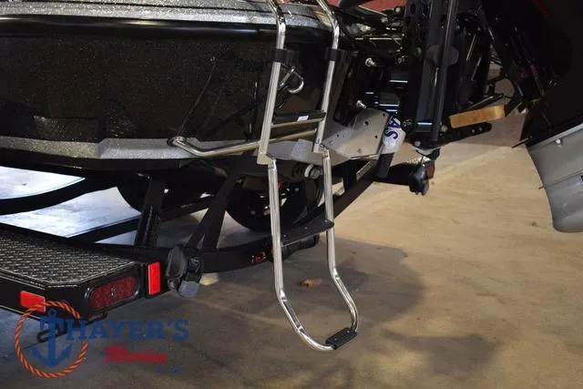 Slide: The Image of 2025 Falcon Bass Boats F20 TE with trailer and boarding ladder in a showroom. - 44