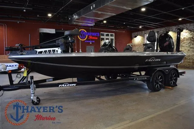 Slide: The Image of 2025 Falcon Bass Boats F20 TE displayed indoors at Thayer's Marine showroom. - 7