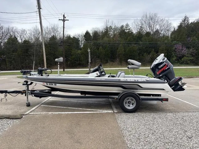 Slide: The Image of 2013 Skeeter TZX190 boat with Yamaha motor on trailer, parked outdoors. - 11