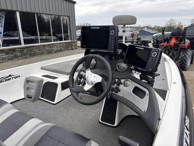 Slide: The Image of 2013 Skeeter TZX190 boat cockpit with steering wheel and electronic displays. - 5