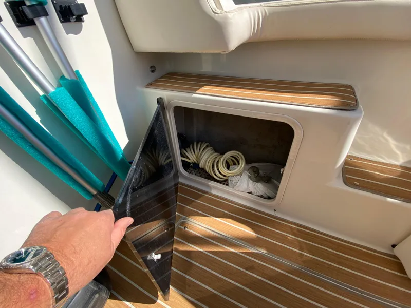 Slide: The Image of Storage compartment on 2008 Meridian 490 Pilot House boat with coiled rope inside. - 13