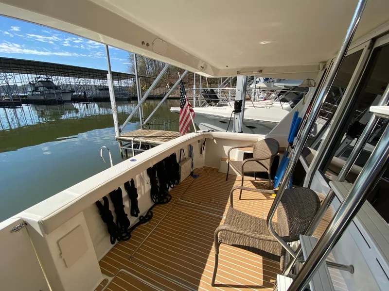 Slide: The Image of 2008 Meridian 490 Pilot House yacht deck with seating and dock view. - 15