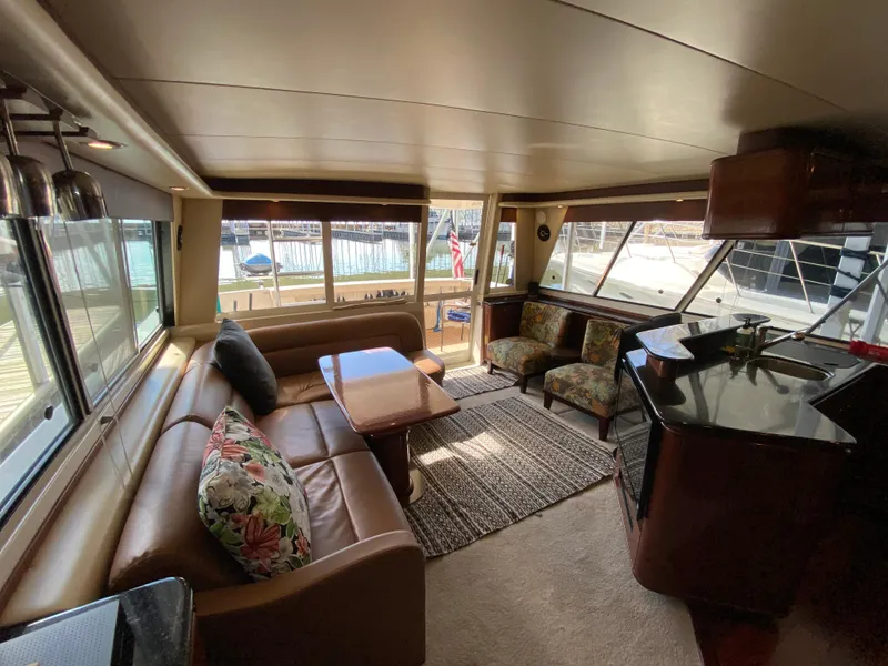 Slide: The Image of Luxurious interior of 2008 Meridian 490 Pilot House yacht with elegant seating and panoramic windows. - 20